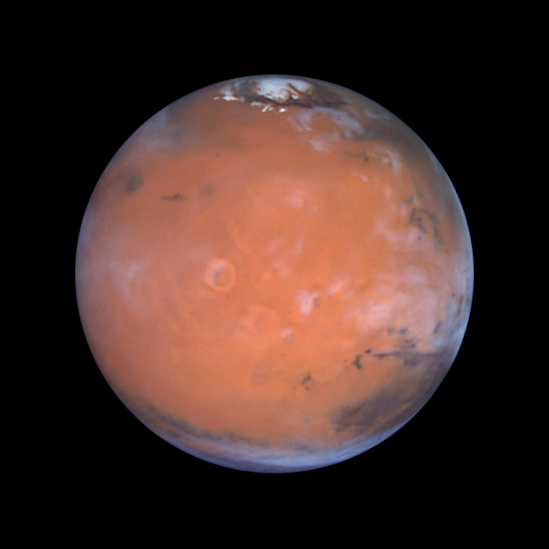 Die Tharsis-Region, aufgenommen vom Hubble-Teleskop. Das Weltraumteleskop machte die Aufnahme 1999, als sich Mars nahe der Erde befand (bei einer Distanz von 87 Millionen Kilometern). In der Tharsis-Region befinden sich die grössten Vulkane des Sonnensystems.  © Steve Lee (University of Colorado), Jim Bell (Cornell University), Mike Wolff (Space Science Institute), and NASA/ESA